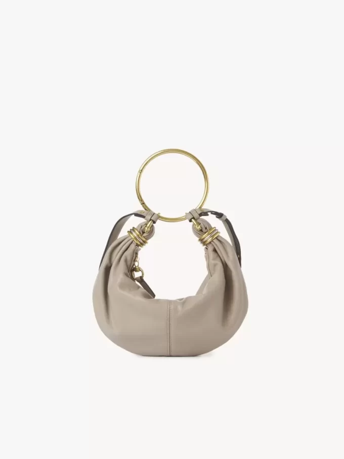 Liten hoboväska med armband i narvat läder Liten hoboväska med armband i narvat läder