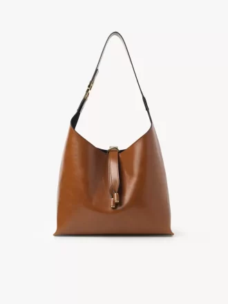 Liten Marcie hobo-väska i glansigt läder Liten Marcie hobo-väska i glansigt läder